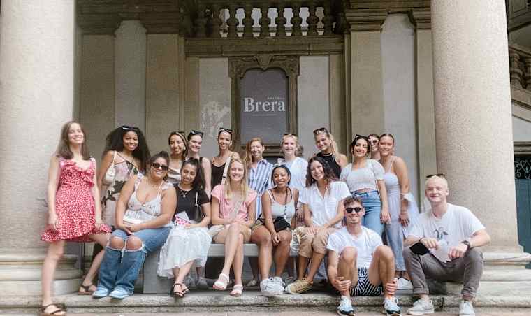 A group of interns outside of a building.