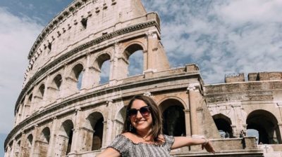 College student in front of the Colosseum in Rome, Italy | AIFS Study Abroad