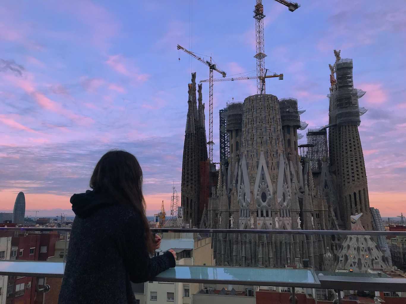 Girl posing in front of building.