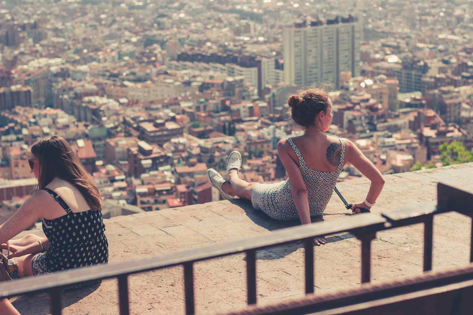 Girls sitting on ledge.