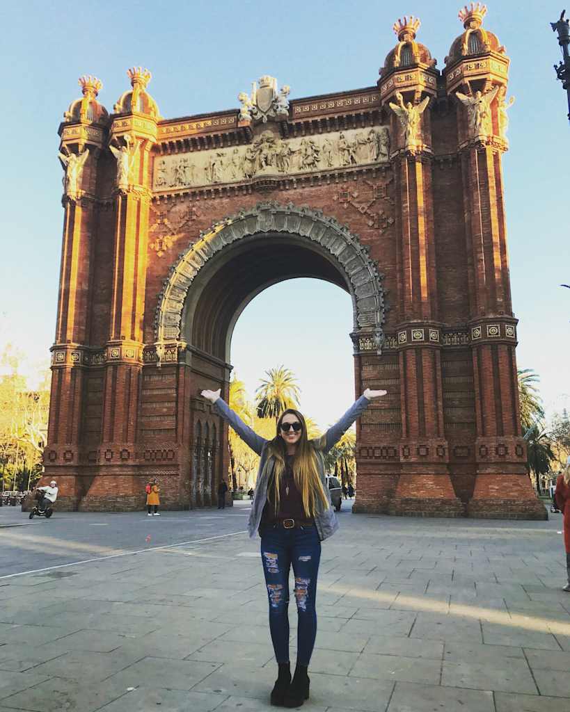 Girl standing in front of arch.