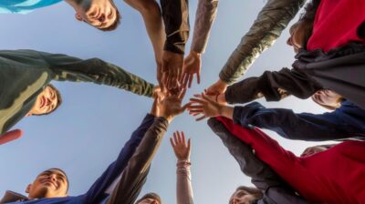 People putting hands in during a huddle. community service concept.