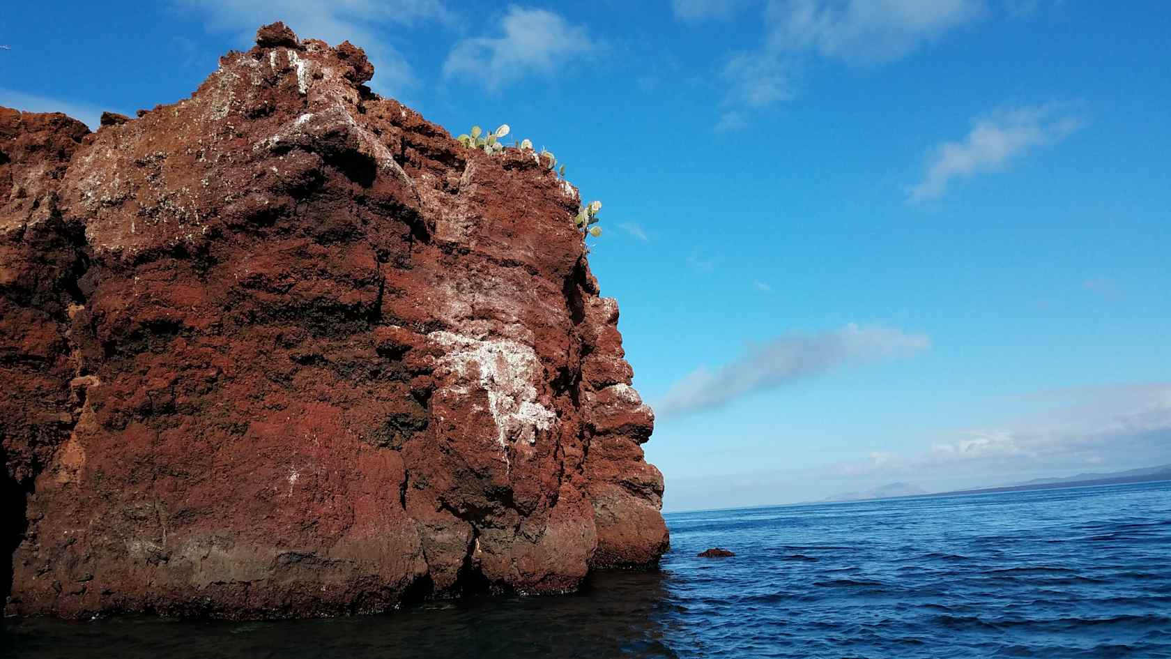 A red cliff alongside the ocean in Ecuador.