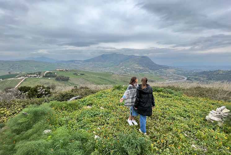 Two students walking in a field.