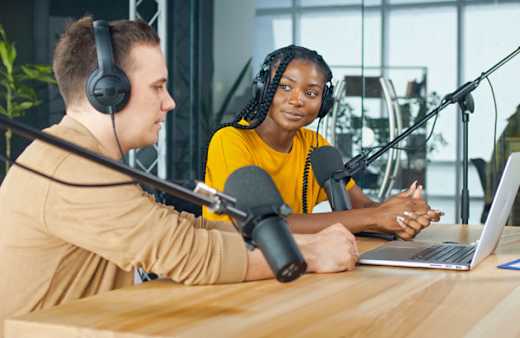 Two students in a recording studio.