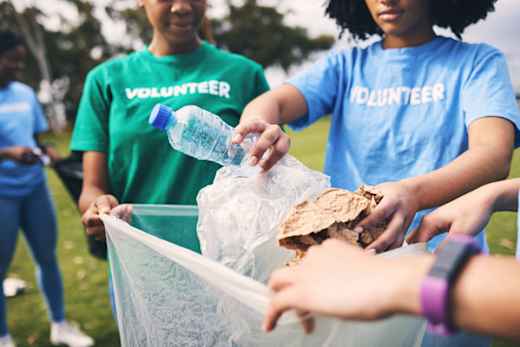 Volunteers clean litter from a park.
