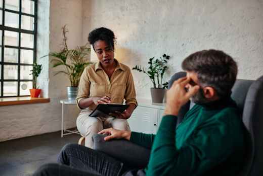 Psychologist takes notes during a session.