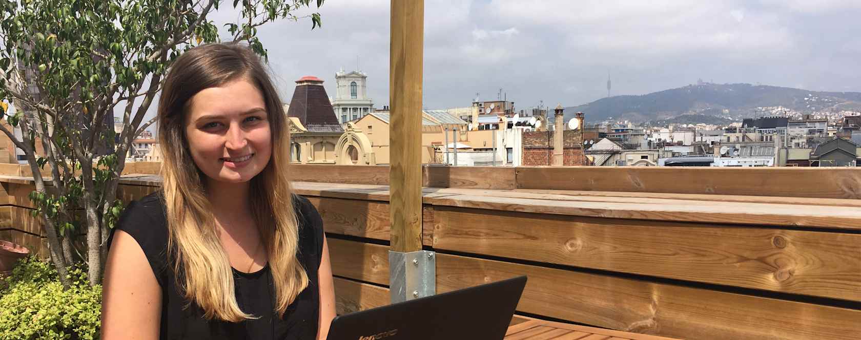 A student working with a laptop outside.