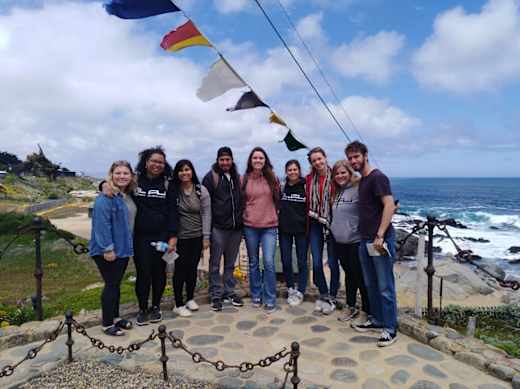 A group of students with an ocean view in the background in Chile.