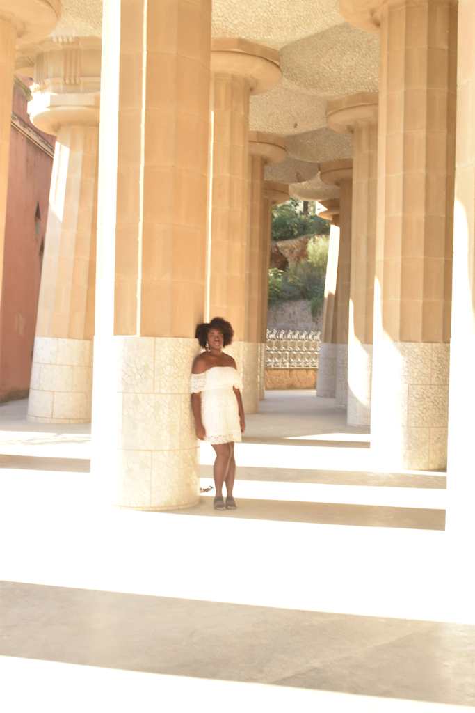 Girl leaning against pole.