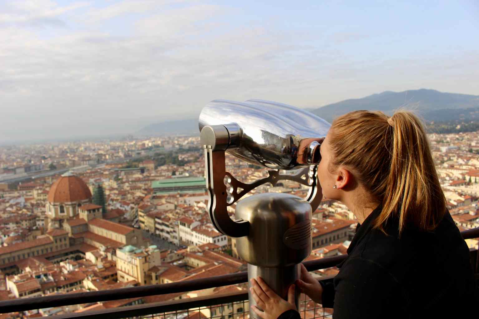 A student looking through a binocular viewer.