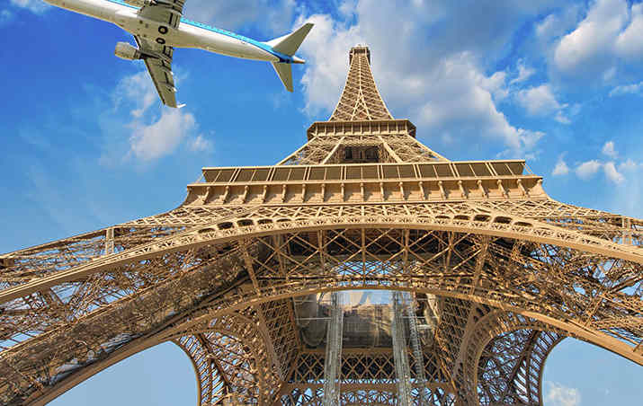Plane flying over the Eiffel Tower in Paris, France.