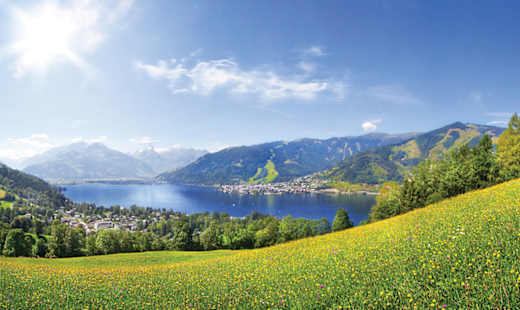 A lake surrounded by green fields.