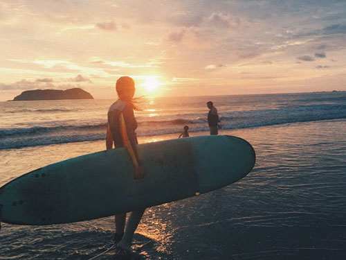 Students surfing on a beach.