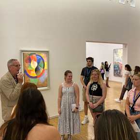A group of students on a tour in an art museum.