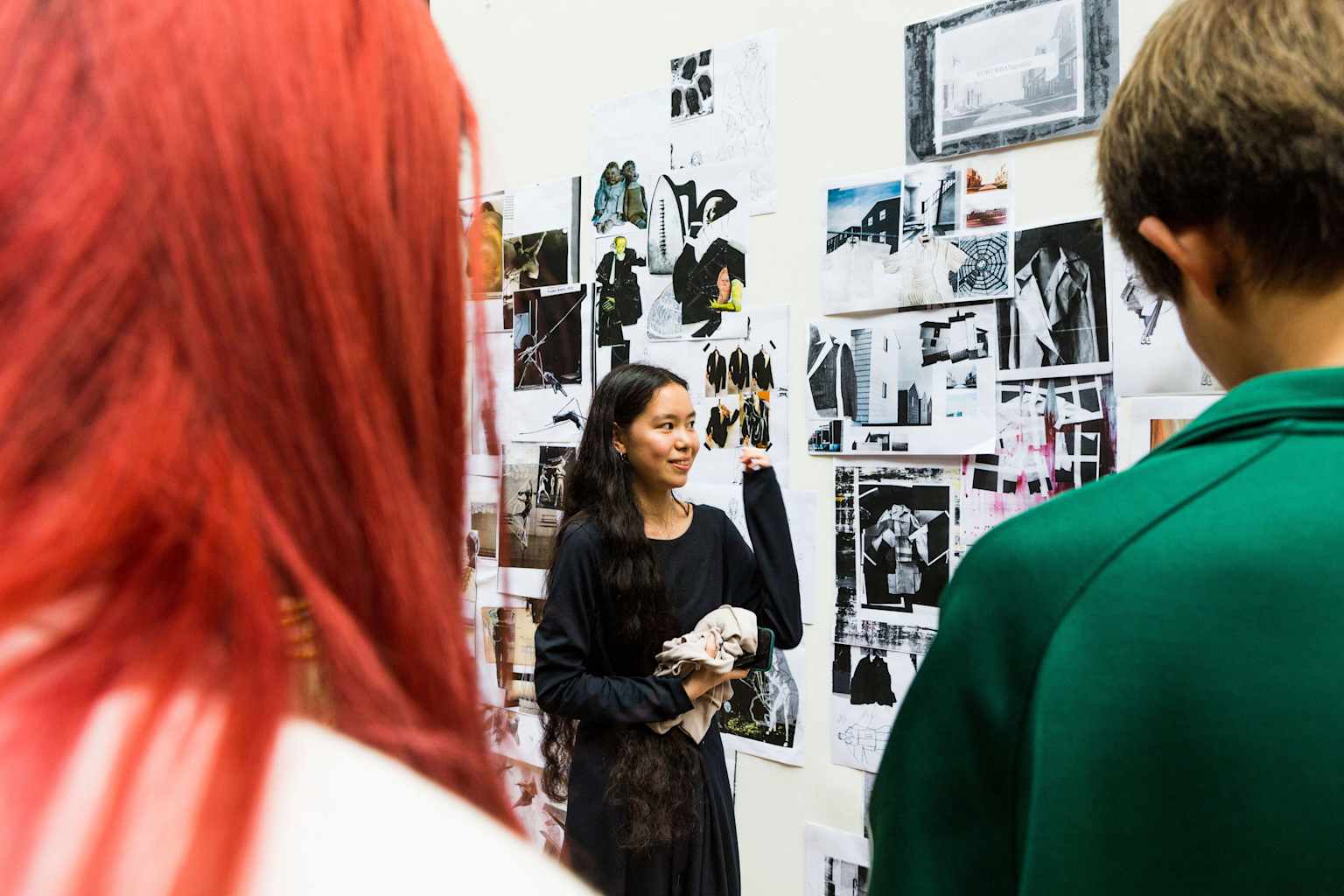 Students looking at art on a wall.