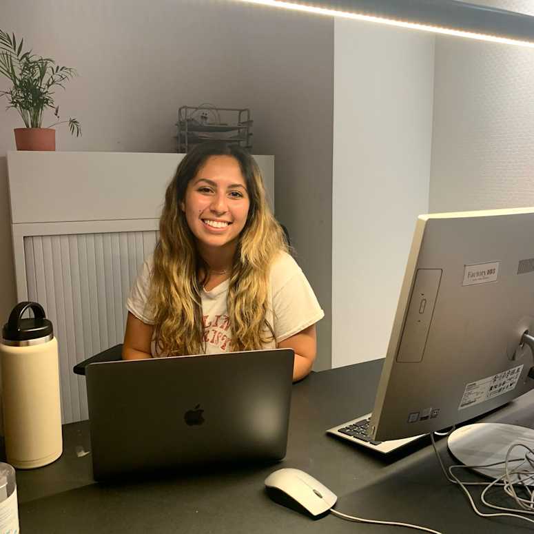 A student working at a desk with a laptop.